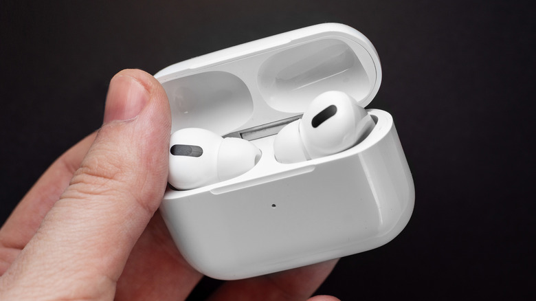 person holding AirPods Pro case